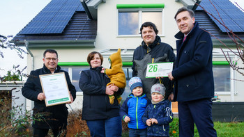 Energiestaatssekretär Thomas Wünsch (r.) übergab Grüne Hausnummer an Familie Schweigel aus Körbelitz